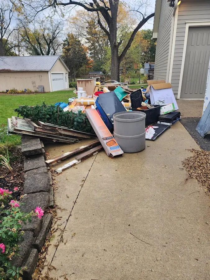 Dumpster being loaded with debris for 12 Yard Dumpster Rental in Seymour